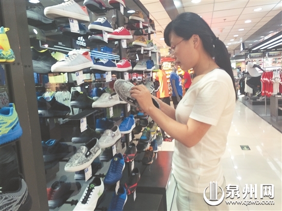 消费者在一品牌鞋专卖店选购鞋子。